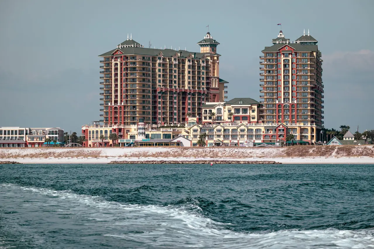 The Emerald Grande towers and lighthouse at HarborWalk Village in Destin, Florida, seen from the water of East Pass