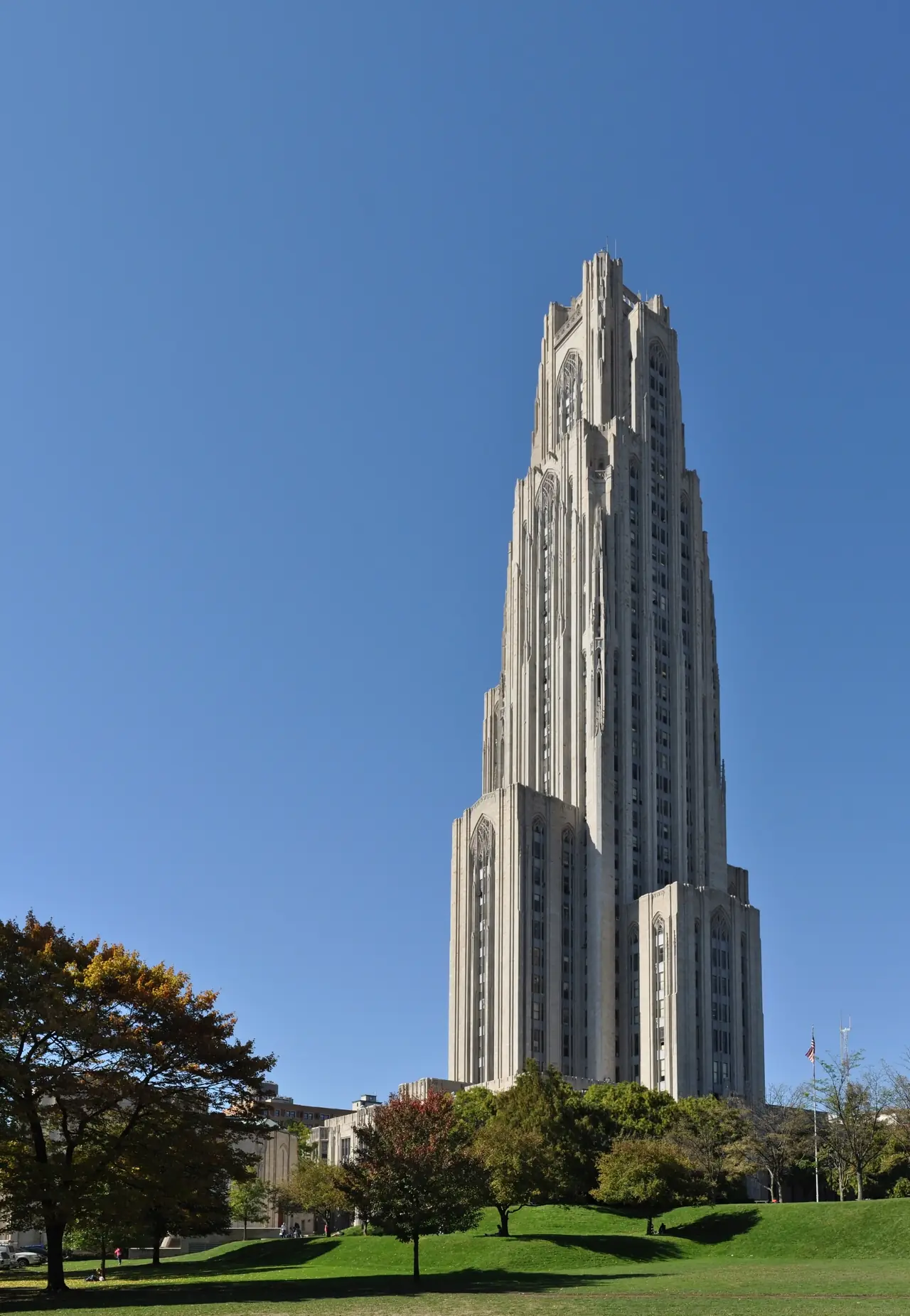 The Gothic Revival Cathedral of Learning tower at the University of Pittsburgh against a clear blue sky
