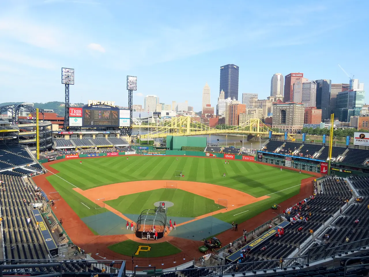 PNC Park's ballfield and stands, with the yellow Roberto Clemente Bridge and downtown Pittsburgh beyond the outfield